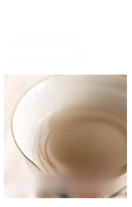 Macro detail of hand-painted peach blossom ceramic teacup rim with smooth finish