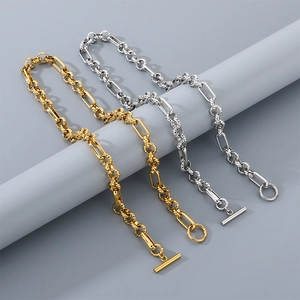 Detail of gold and silver stainless steel OT toggle necklaces with textured link chains