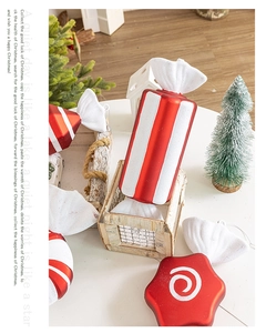 Detail of red and white striped Christmas candy ornaments with glitter texture on table
