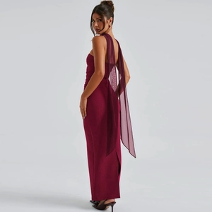 Detail of burgundy long evening gown showing the open back and flowing chiffon sleeves
