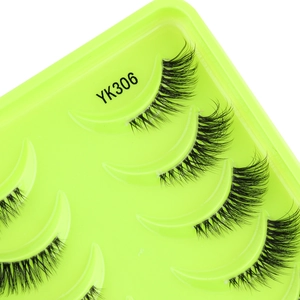 Close-up of YK306 half eyelashes with criss-cross pattern and dense texture on green tray