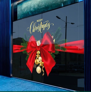 Detail of Christmas window sticker with red bow, golden bells and Merry Christmas text