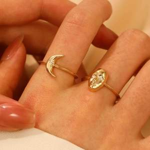 Golden crescent moon and embossed face ring set with sparkling crystal accents