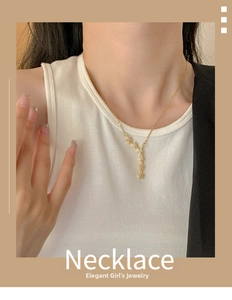 Detail of gold star tassel necklace with sparkling zircon stars on a delicate chain