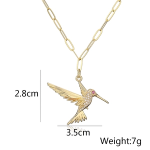 Close-up of 18K gold plated hummingbird pendant necklace with sparkling zircon pavé