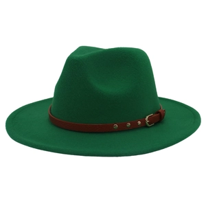 Detail of dark green wool fedora hat featuring a brown leather band and gold buckle
