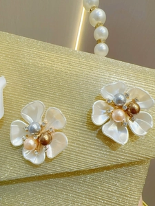 Sparkly evening clutch bag with elegant resin floral accents and shimmering sequins