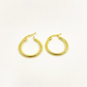 Macro shot of minimalist gold hoop earrings with a smooth polished finish on white background