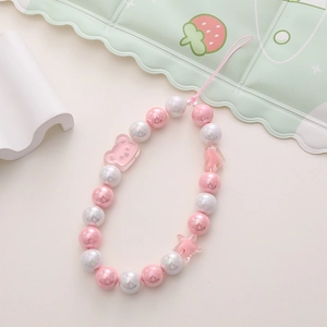 Pastel pink and white beaded phone charm with cute resin bear and star pendants