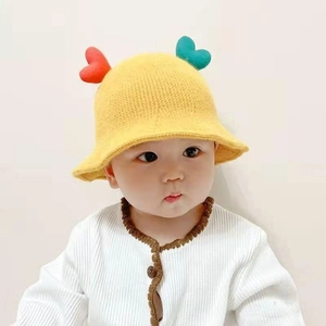 Cute yellow knit baby bucket hat with colorful heart accents on soft knitted fabric
