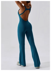 Detail of teal backless yoga jumpsuit with crisscross straps and flared leg design