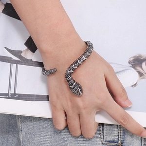 Detailed view of vintage silver snake scale texture on a punk-style wrap bracelet