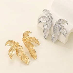 Exaggerated metal leaf earrings with wrinkled texture in gold and silver finish