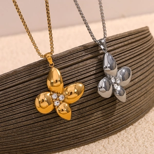 Detailed macro of 18K gold and silver petal pendants with sparkling rhinestones