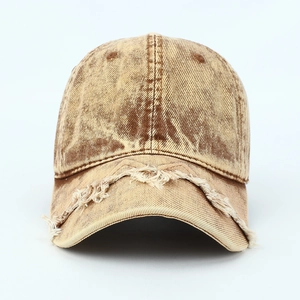 Close-up of vintage distressed tan baseball cap featuring frayed edges and worn details