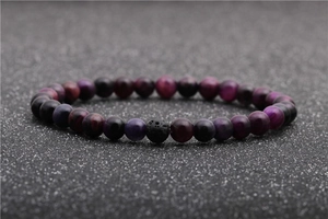 Detailed view of purple tiger eye stone and black lava rock beads on an elastic bracelet