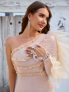 Detail of silver rhinestone tassel earrings and teardrop gem hand chain with sequins