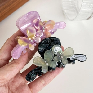 Elegant acetate butterfly hair claw clip with rhinestones in purple and green marble patterns