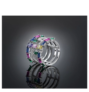 Macro detail of the silver wide-band ring with multi-colored zircons and H-shaped cutouts