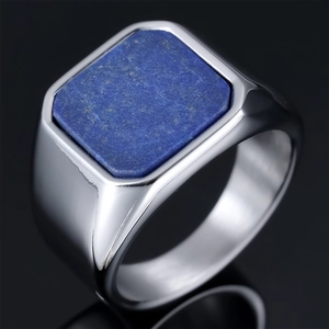 Macro close-up of a men's silver stainless steel ring with a square blue lapis stone