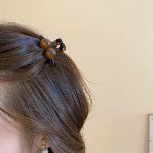 French retro amber acrylic mini hair claw clip shown on brunette hair for daily style