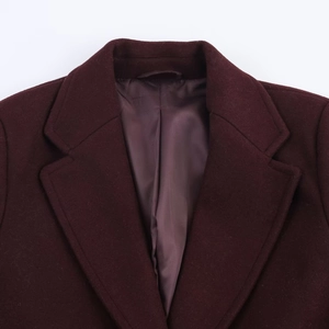 Detail of classic notched lapel on a burgundy slim-fit wool coat with premium texture