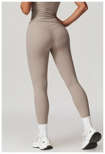 Detail view of high-waist taupe yoga leggings featuring V-shaped back seam for butt lifting