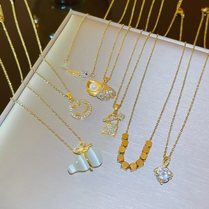 Collection of elegant gold titanium steel necklaces featuring pearl shells and gemstone pendants