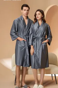 Detail of dark gray striped satin robe with elegant white piping and matching waist tie