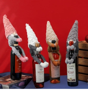 Detail of plush gnome wine bottle covers in pink, white, khaki and grey for Christmas