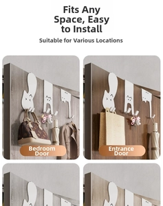 Detailed view of white cat silhouette door hooks used for organizing clothes and keys