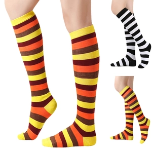 Detail view of festive orange and black striped knee-high socks for Thanksgiving