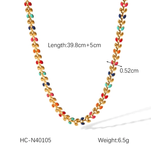Detail view of gold chain with colorful enamel leaves and precise size measurements