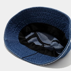 Detail of blue denim bucket hat interior with sweatband and adjustable drawstring