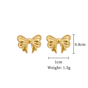Macro shot of gold bow stud earrings with size annotations showing 1cm width and 0.8cm height