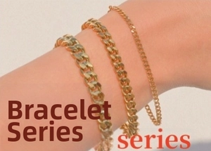 Detailed view of three gold-plated stainless steel Cuban link bracelets on a wrist