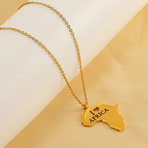 Macro detail of gold plated stainless steel Africa map pendant with heart cutout design