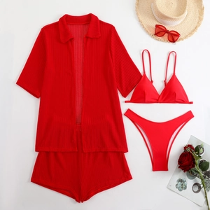Flat lay of red 4-piece beach set including mesh shirt and bikini with holiday accessories