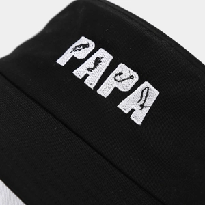 Macro view of white PAPA 3D embroidery with fishing elements on black cotton bucket hat