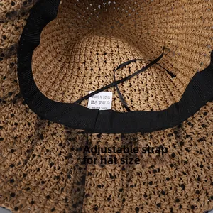 Close-up of paper straw sun hat interior with sweatband and adjustable sizing cord