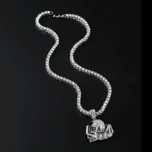 Macro shot of silver hip hop tennis chain with iced out cash stack and skull pendant
