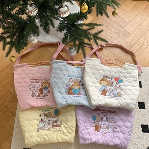 Detailed flat lay of quilted cotton tote bags in five macaron colors with cute embroidery