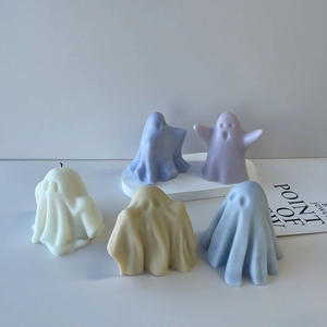 Ghost-shaped scented candles in various pastel colors on a white minimalist display stand