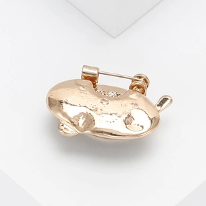 Close-up of the smooth golden metal brooch back showing the secure pin attachment