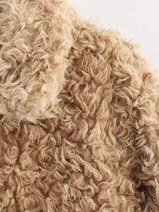 Detailed close-up showing high-density curly faux shearling fabric in warm khaki brown