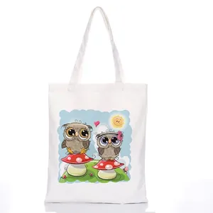 White canvas tote bag featuring a colorful cartoon owl and mushroom illustration print