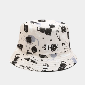 Detailed close-up of cute cartoon cat and meow patterns on a light beige cotton bucket hat