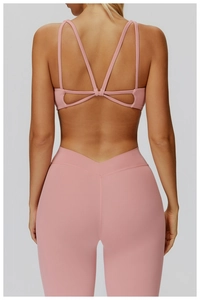Detailed back view of pink yoga bra featuring cross straps and high-elastic fabric