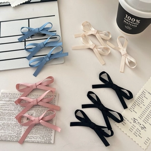 Set of satin bow hair clips in blue, cream, pink and black with metal duckbill base
