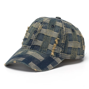 Detail of blue denim baseball cap featuring unique wide-strip woven texture and distressed fringe
